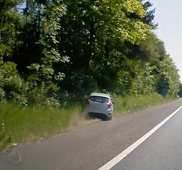 The silver hatchback swerved across the A1M, near Welwyn Garden City, Hertfordshire, before plowing into roadside bushes