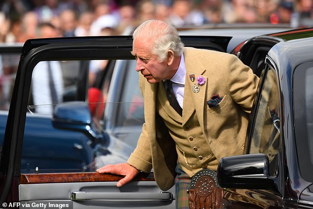 King Charles III offers a car when he arrives to attend the annual Braemar Gathering in Braemar, central Scotland