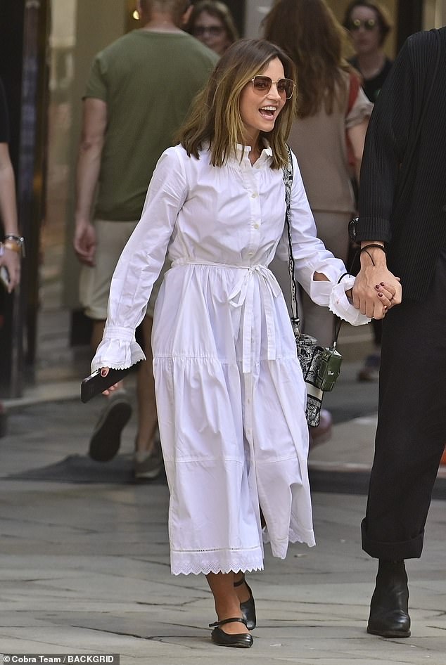 Outfit: The actress, 37, looked classy for the outing as she donned a long-sleeved white midi dress with a patterned hem