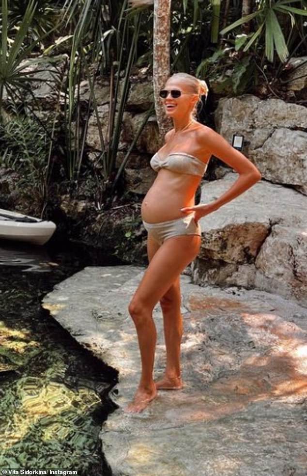 Stunning: The mom-to-be showed off her fabulous figure as she donned a beige strapless bikini while smiling in the photo