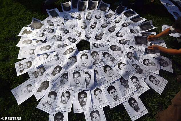 Photos of missing students are seen during a march in support of the missing students of the Ayotzinapa Teacher Training College in Mexico City, Mexico