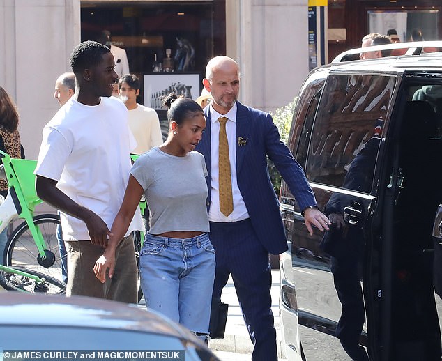 All smiles: Damson Iris also sported a casual figure in an oversized white tee and olive pants and was all smiles as the couple left the lavish restaurant