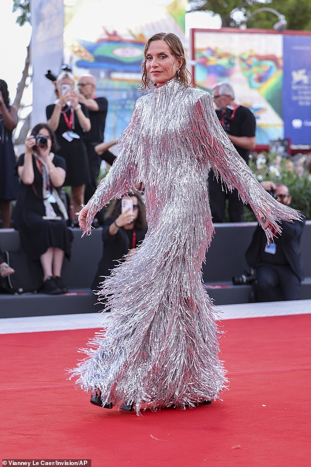 Bold look: She was the epitome of French chic in the bold statement dress, featuring a high neckline, long fringed sleeves and a maxi length