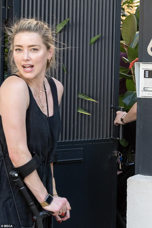 Casual: She did her best to beat the humidity in a sleeveless black maxi dress, which she paired with Chloé white linen slippers, and her hair in a sleek bun