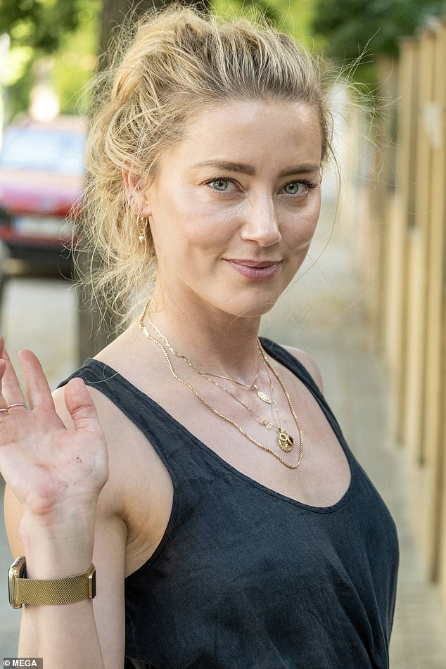 Stylish: Heard styled her relaxed look with hoop earrings, an Apple Watch with a gold strap and multiple necklaces