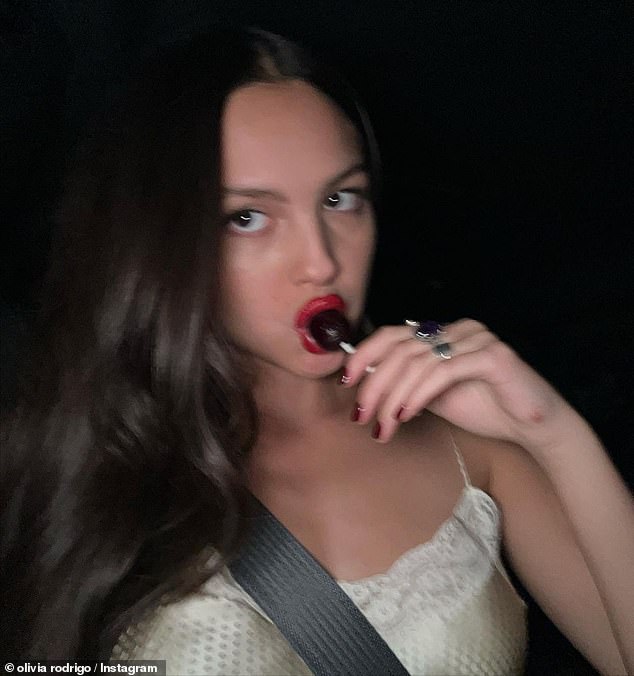 Selfie time: The artist also took a slightly blurry selfie in a dimly lit car while enjoying a sweet lollipop