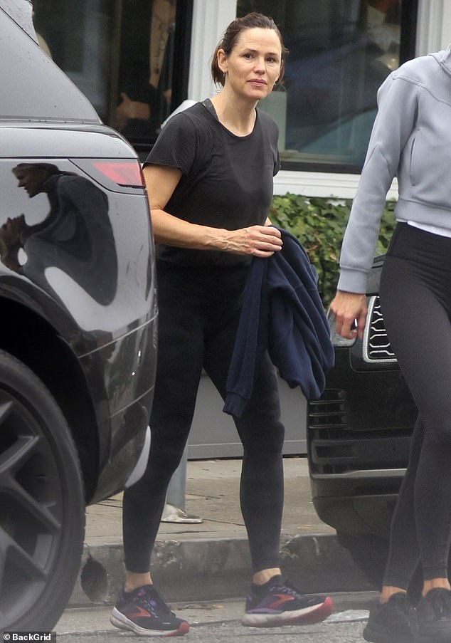 The 51-year-old actress was spotted jogging with a friend through her Brentwood neighborhood during the light rainstorm