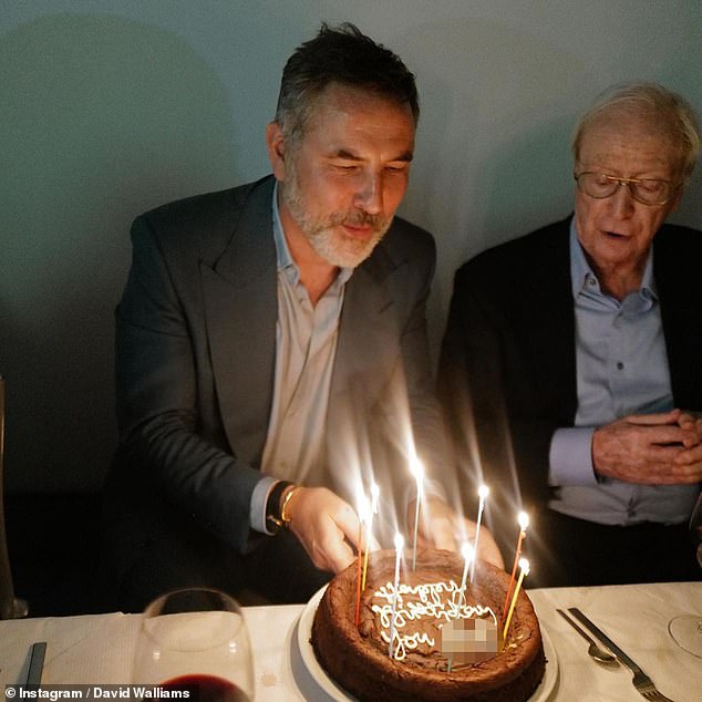 Bon appetit: In one of the photos, David was seen blowing out the candles on a yummy-looking cake with an expletive-laden message