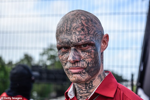 A neo-Nazi from the Blood Tribe group poses for a photo at a rally