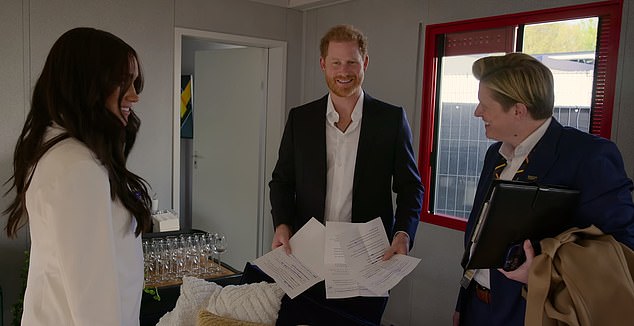 Prince Harry's new Netflix documentary 'Heart Of Invictus' has reportedly failed to reach the Netflix Top 10 streaming charts.  He is pictured in the series (center) along with Meghan Markle (left)