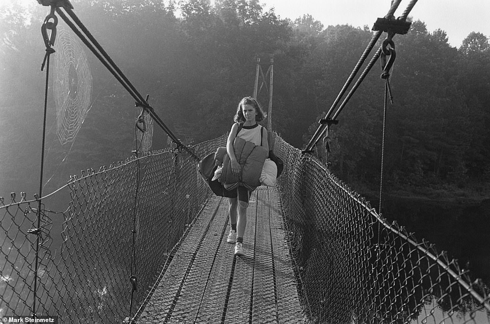 Traditional activities include walking, fishing, cooking, dancing, sports and letter writing (pictured is a girl crossing a bridge with her sleeping pack)