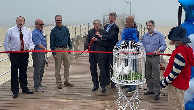 Badger cuts the ribbon at the pier opening ceremony on the beach just south of Asbury Park