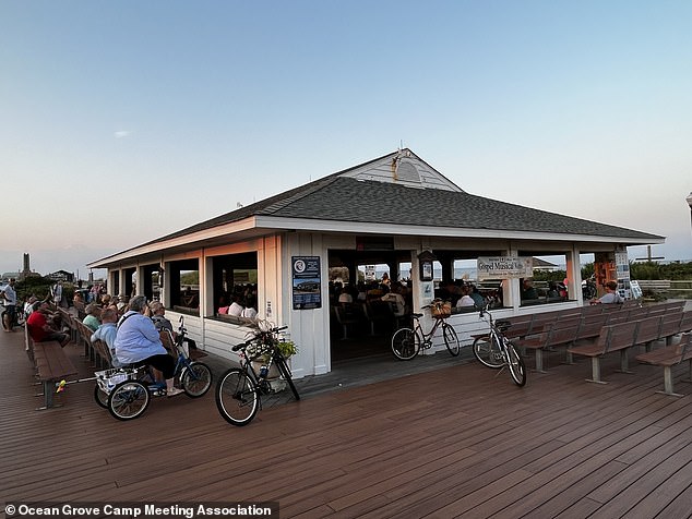 Residents and visitors attend a gospel music performance on the controversial pier