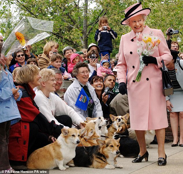 Queen Elizabeth II is greeted by local Corgi enthusiasts in Edmonton as she exits the Legislature Building on a tour of Canada.