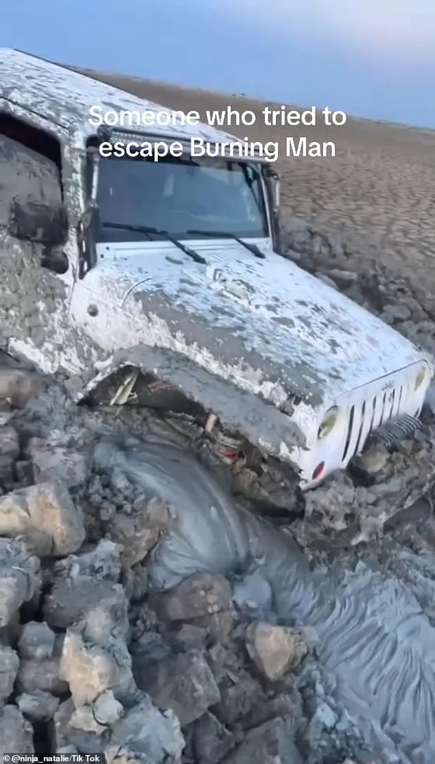 One clip posted by a festival-goer showed a jeep half-buried in the sinking clay and mud – completely unable to move after getting stuck in the silt