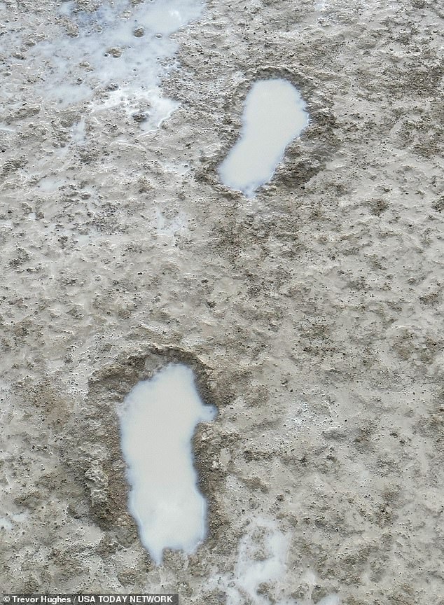 Muddy footprints quickly fill with rainwater after the downpours