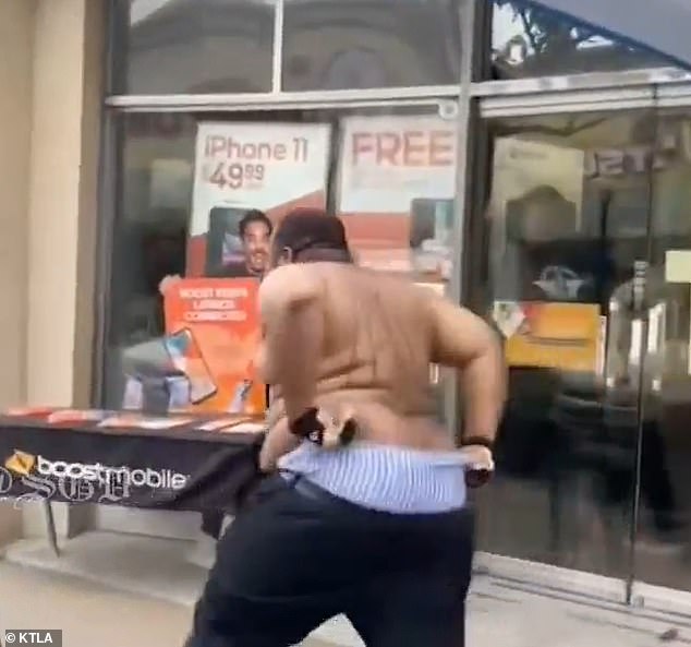 The man fled down the street as employees chased him and his pants fell down