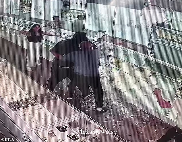 One of the employees is seen struggling with the would-be thief during the attempted robbery