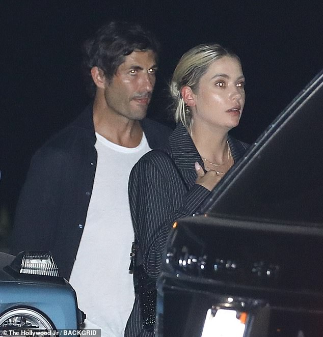 Striking: The Spring Breakers actress wore a slightly oversized pinstripe jacket over a black shirt on her night out, while her boyfriend kept casual in a white T-shirt and black jacket