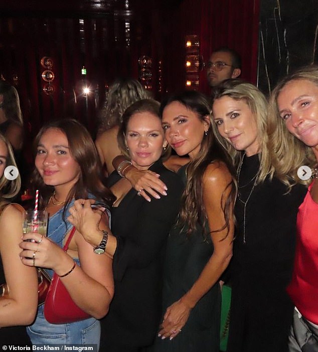 Letting her hair down: Victoria looked like she was also enjoying the party as she posed with girlfriends