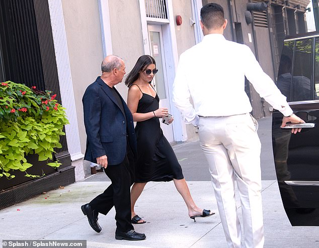 Completing the look: She wore sunglasses and her gorgeous dark brown hair fell to her shoulders