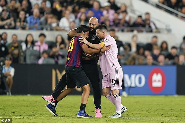 The World Cup winner's bodyguard quickly sprang into action and snatched the supporter away