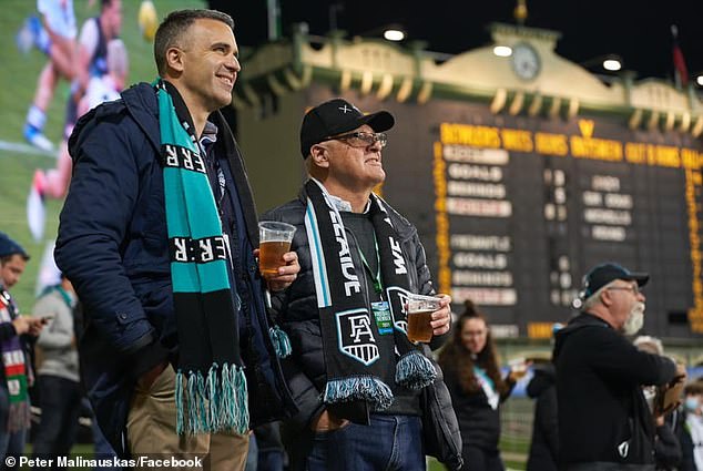 Malinauskas (pictured during an AFL match with his dad) says he uses sleds a lot when he's playing football