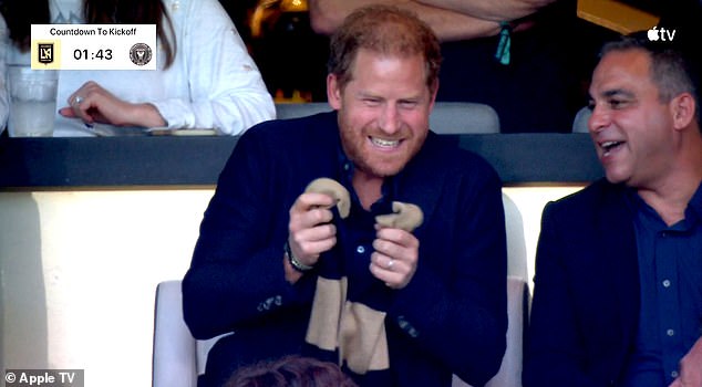 Dizzy: Prince Harry, 38, looked giddy as he watched the action unfold