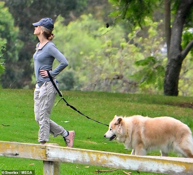 Dog Mom: Renee strolled around in a pair of pink sneakers while walking Dylan on his leash