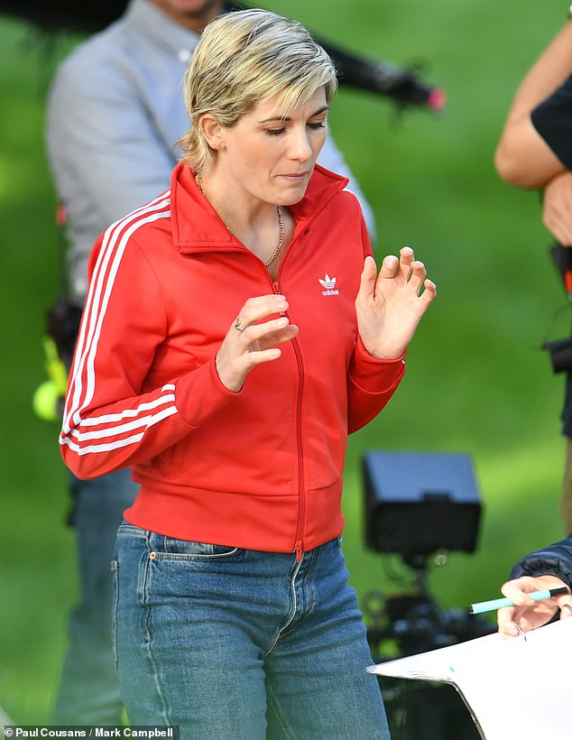 Stepping into character: Jodie looked edgy as she wore dark washed denim jeans and a pair of classic black and white Adidas sneakers, with a gold chain