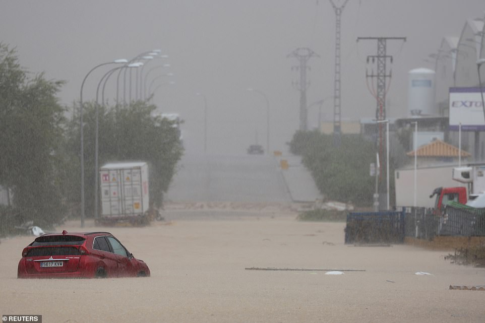 A car is stranded on a flooded road after heavy rain in Toledo, Spain September 4, 2023