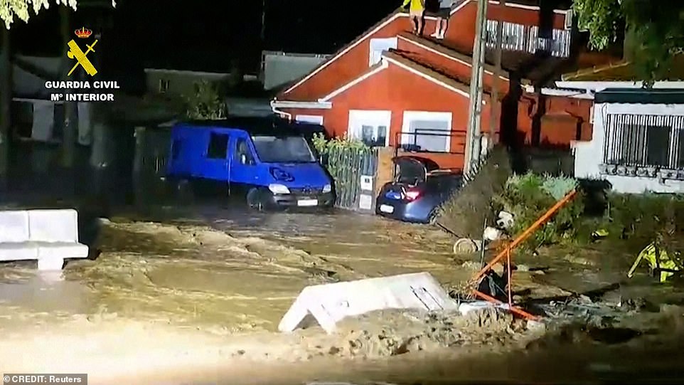 Flooding was seen sweeping through a town in Spain last night