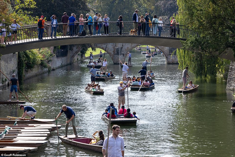 People enjoy the warm weather on a punting trip on the River Cam in Cambridge on Sunday