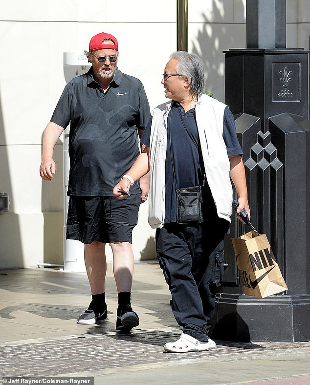 His helper was seen following him with other items and presumably Perry's previous clothes in a shopping bag