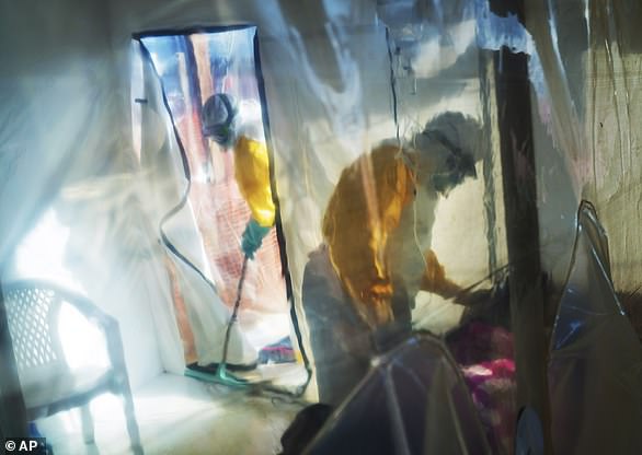 Health workers attend to an Ebola patient held in an isolation tent in the Democratic Republic of Congo in July 2019