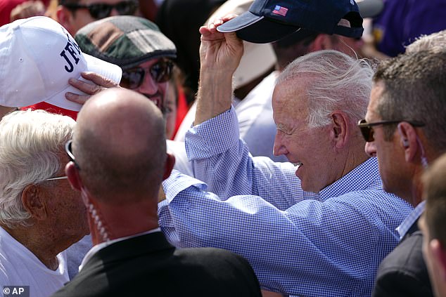 President Joe Biden exchanges hats with a man after a Labor Day speech in Philadelphia, Pennsylvania