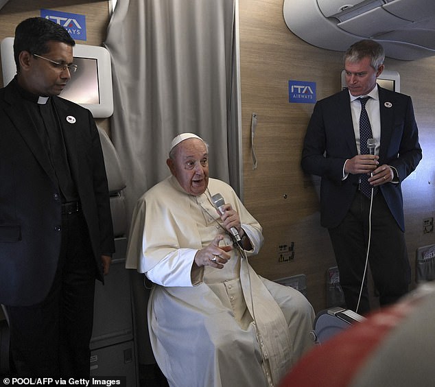 Pope Francis attends Monday's press conference with accredited journalists on their return flight from Mongolia