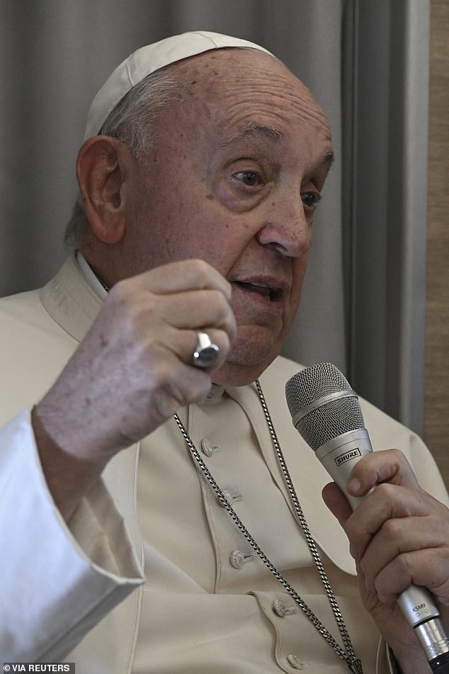 Pope Francis speaks at a press conference aboard the papal plane on his flight back from a visit to Mongolia on Monday