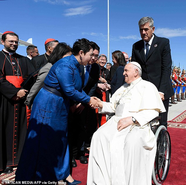 Pictured: Pope Francis shakes hands with Mongolian Foreign Minister Batmunkh Battsetseg as he sits in a wheelchair before leaving the country on Monday