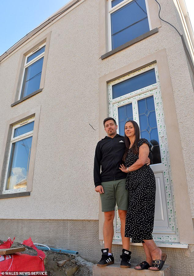 Jessica Williams with partner Mike outside their rebuilt home thanks to residents