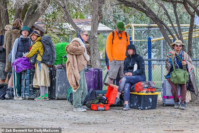 Visitors wait for shuttles away from the desert and the cold weather sets in outside a playground in Gerlach, NV, on Sunday