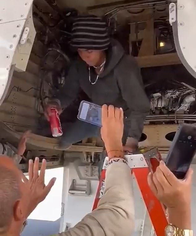 César climbs out of the landing gear of a Volaris Airlines plane before being taken into custody by soldiers at Mexico City International Airport