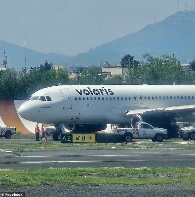 Mexico City International Airport security guard guards the Volaris Airlines plane that pulled a teenager from the landing gear area