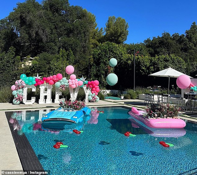 The party consisted of a bright pink telephone with dial tone on the wall, huge neon light signs, vinyl discs, bar stools and two inflatable cars in the pool with roses in them.