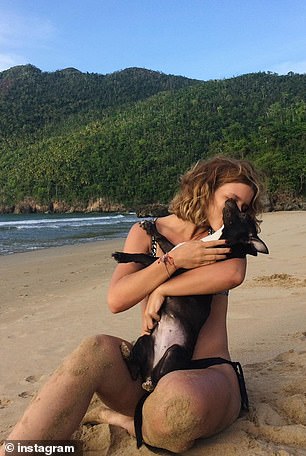 Rodriguez and Maia pose for a photo on the beach