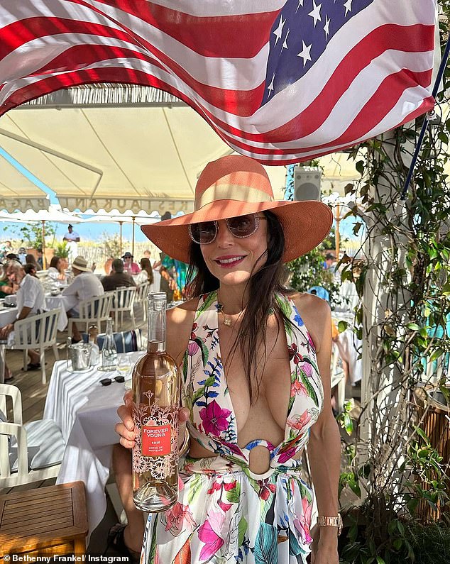 Having fun: The entrepreneur ended up donning a floral print dress while enjoying lunch by the sea