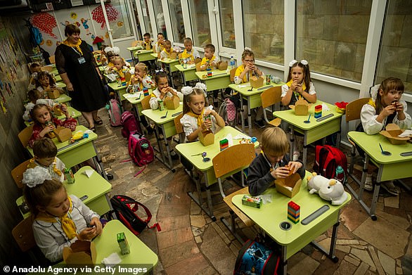 Children go to the first day of school in a subway