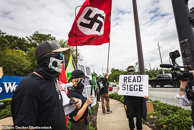 Members of the neo-Nazi group 'Order of The Black Sun' protest at the entrance to Walt Disney World in Orlando, Florida in support of Florida Governor Ron DeSantis