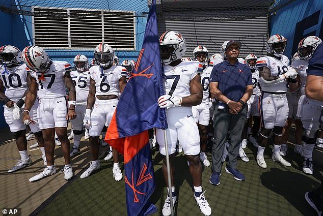 Shooting survivor and running back Mike Hollins led the Cavaliers out of the tunnel in Week 1