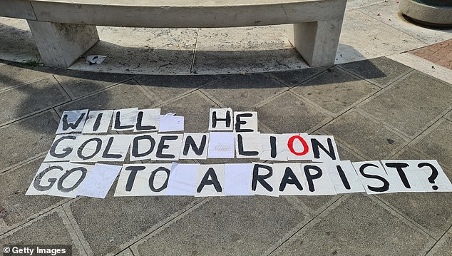 Graffiti can be seen on the ground during a protest at the Venice International Film Festival on Monday